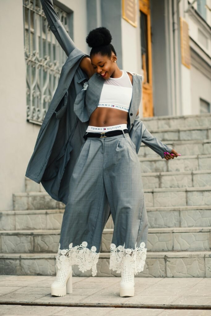 pexels-photo-914668-914668 Confident young woman in chic outfit posing outdoors in a lively urban environment.
